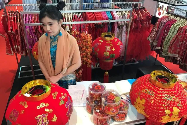 A woman sells colorful clothes ahead of Chinese New Year celebration in Bangkok, January 23, 2017. (Photo by Jorge Silva/Reuters)