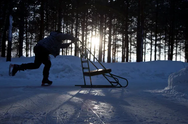 A boys skates through the forest at Domaine de la Foret Perdu or the Lost Forest, a 15km weaving and zambonied forest trail made for skating in Notre-Dame-du-Mont-Carmel, near Three Rivers, Quebec January 29, 2017. (Photo by Christinne Muschi/Reuters)