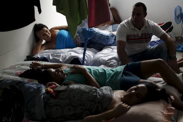 Cuban migrants rest inside a room at an old hotel used as a provisional shelter in Paso Conoa, at the border with Costa Rica March 20, 2016. (Photo by Carlos Jasso/Reuters)