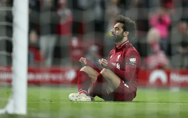 Liverpool's Mohamed Salah sits in front of the goal after scoring his side's fifth goal during the English Premier League soccer match between Liverpool and Huddersfield Town at Anfield Stadium, in Liverpool, England, Friday, April 26, 2019. (Photo by Jon Super/AP Photo)