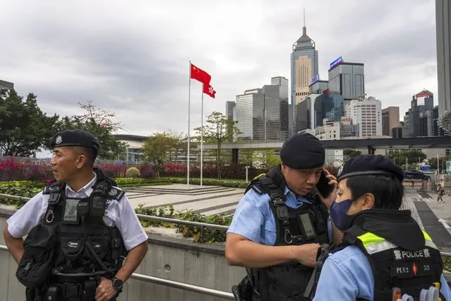 Police officers stand guard outside the Legislative Council in Hong Kong, Tuesday, March 19, 2024. Hong Kong's lawmakers met in a special session to resume debate on a proposed national security law Tuesday, paving the way to grant the government more power to quash dissent in the southern Chinese city. (Photo by Louise Delmotte/AP Photo)