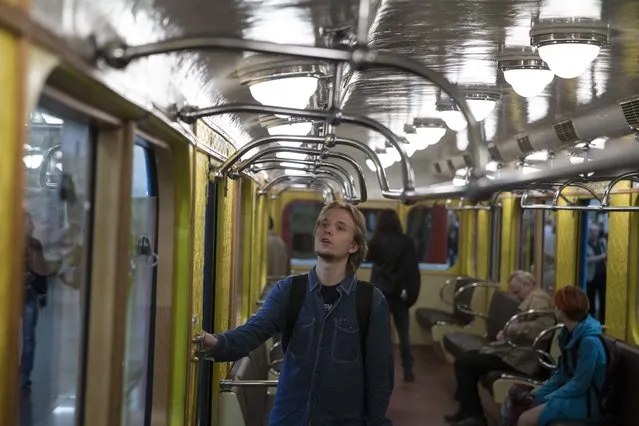 People walk in a Soviet-era vintage subway car, parked in the Partizanskaya subway station, in Moscow, Russia, Friday, May 15, 2015. (Photo by Pavel Golovkin/AP Photo)