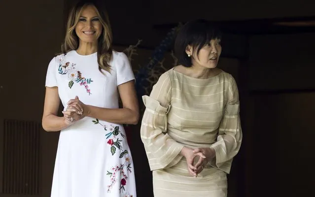 U.S. First Lady Melania Trump (L) and Akie Abe, wife of Japanese Prime Minister Shinzo Abe (R) look at koi carps in a pond at the Japanese style annex inside the State Guest House on May 27, 2019 in Tokyo, Japan. President Donald Trump is on the third day of a four day state visit to Japan, the first official visit of the country's Reiwa era. Alongside a number of engagements, Mr Trump was guest of honour at a Sumo wrestling match on Sunday and is expected to meet families of North Korean abductees. (Photo by Tomohiro Ohsumi/Getty Images)