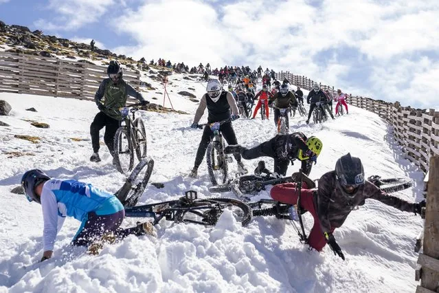 Cyclists take part in MacAvalanche, a mass mountain bike race through the snow, descending over 900m from the summit of Aonach Mor in the Nevis Range near Fort William, Scotland on Saturday, April 20, 2024. (Photo by Jane Barlow/PA Images via Getty Images)