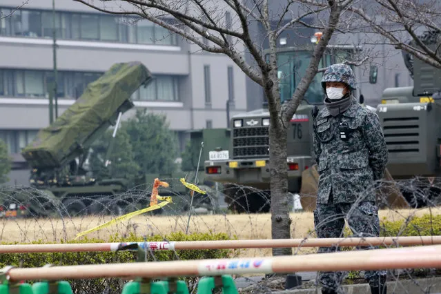 A member of Japan Self-Defense Force stands by a PAC-3 Patriot missile unit deployed against the North Korea's missile  firing, at the Defense Ministry in Tokyo, Monday, March 6, 2017.  North Korea on Monday fired four banned ballistic missiles that flew about 1,000 kilometers (620 miles), with three of them landing in Japan's exclusive economic zone, South Korean and Japanese officials said, in an apparent reaction to huge military drills by Washington and Seoul that Pyongyang insists are an invasion rehearsal. (Photo by Shizuo Kambayashi/AP Photo)