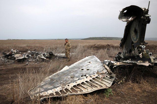 Hero of Ukraine Lieutenant Colonel Serhiy Verbytsky examines the remains of his SU-24M aircraft on the outskirts of the town of Izyum, Kharkiv Region, on April 17, 2024, amid the Russian invasion in Ukraine. On March 22, 2022, the crew of the SU-24M bomber, consisting of pilot Oleksiy Kovalenko and navigator Serhiy Verbytsky, bombed a column of Russian heavy equipment, after which their plane was shot down. The pilot Oleksiy Kovalenko died, and the navigator Serhiy Verbytskyi managed to eject and the injured man to get to the Ukrainian positions. Both pilots were awarded the title Hero of Ukraine. (Photo by Anatolii Stepanov/AFP Photo)