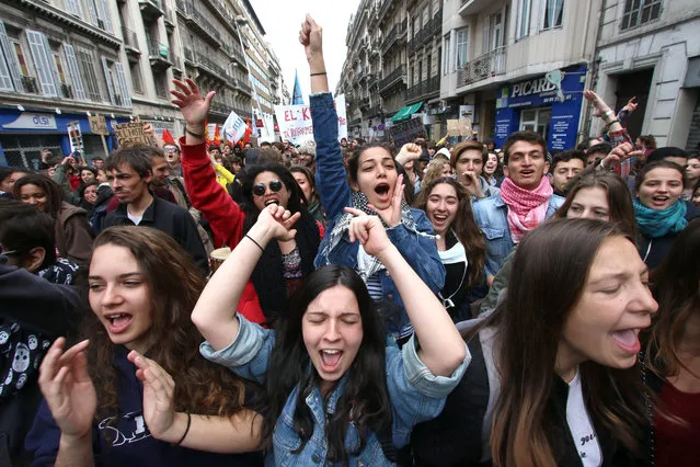 Students shout slogans during a demonstration in Marseille, southern France, Thursday, April 28, 2016, during a nationwide day of protest.  Student organizations and employee unions have joined to call for protests across France to reject a government reform relaxing the 35-hour working week and other labour rules. (Photo by Claude Paris/AP Photo)