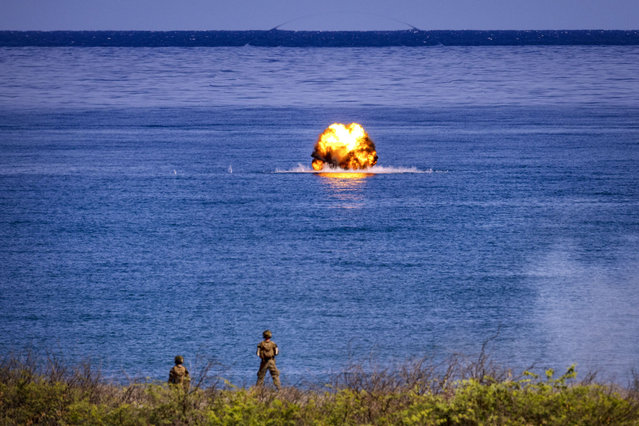 U.S. troops watch as a Javelin missile hits a target at sea during a counter landing live fire exercise as part of U.S.-Philippines joint military exercises on May 06, 2024 in Laoag, Ilocos Norte province, Philippines.  The Philippines and the United States initiated their largest Balikatan (shoulder-to-shoulder) joint military exercises, involving 16,000 troops, with drills extending beyond the Philippines' territorial sea into the contentious South China Sea, directly opposing China's broad claims. The exercises also include drills in the Philippines' northern Cagayan province, near Taiwan. These war games follow an incident where the Philippines accused China of attacking their ships with water cannons near the disputed Scarborough Shoal, damaging vessels and injuring crew members. (Photo by Ezra Acayan/Getty Images)