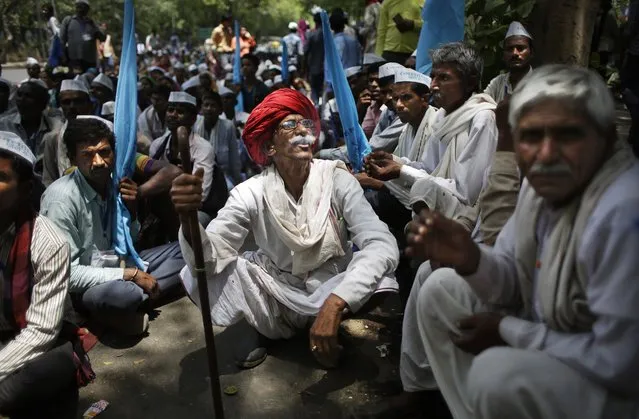 An elderly Indian villager, centre, smokes as he participates in a protest demonstration to highlight the water shortage across the country in New Delhi, India, Thursday, May 5, 2016. Much of India is reeling under a heat wave and severe drought conditions that have decimated crops, killed livestock and left at least 330 million Indians without enough water for their daily needs. (Photo by Altaf Qadri/AP Photo)