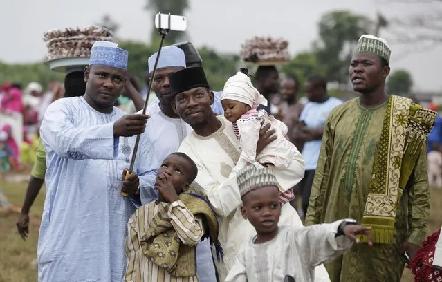 A Nigeria Muslim family takes a selfie portrait before Eid al-Fitr prayer, marking the end of the Muslim holy fasting month of Ramadan in Lagos, Nigeria, Friday, July 17, 2015. (Photo by Sunday Alamba/AP Photo)