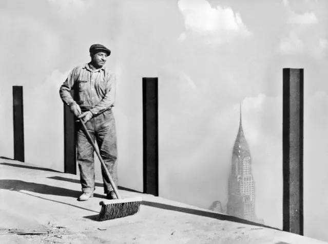 A workman sweeping the highest sidewalk in the world, the 81st story of the Empire State Building, the world's tallest building, to the top of which the greatest dirigible “Los Angeles” will attempt to moor, New York, New York, early 1930s. This photo was made 1,248 feet above street level. (Photo by Adam Glickman/Underwood Archives/Getty Images)