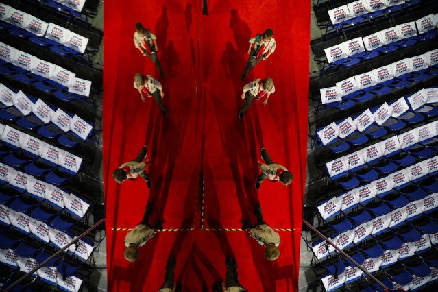 Boy scouts are reflected as they walk on Day 3 of the RNC in Milwaukee on July 17, 2024. (Photo by Brian Snyder/Reuters)