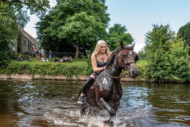 Gypsies gather at Appleby in Cumbria, United Kingdom on August 12, 2021, for the biggest horse fair of its kind in Europe, which lasts till Sunday. Typically the fair takes place in June, although COVID has pushed it back to August in 2021. In the region of 30,000 people are expected to attend. (Photo by Chris Strickland/Alamy Live News)