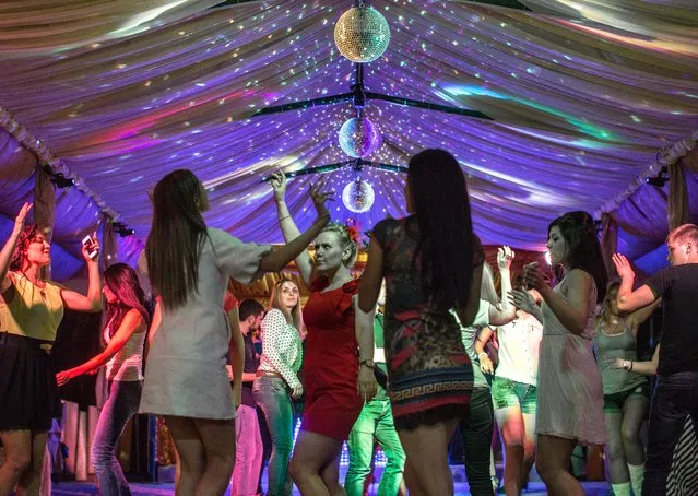 Young Ukrainians dance at nightclub House of Meteorologists, May 23, 2014. Sunday's upcoming election in Ukraine has not only exposed the divide between east and west, but between old and young.  Unlike their elders, younger people have no memory of Soviet life, and most see themselves as Ukrainian. (Photo by Evelyn Hockstein/The Washington Post)