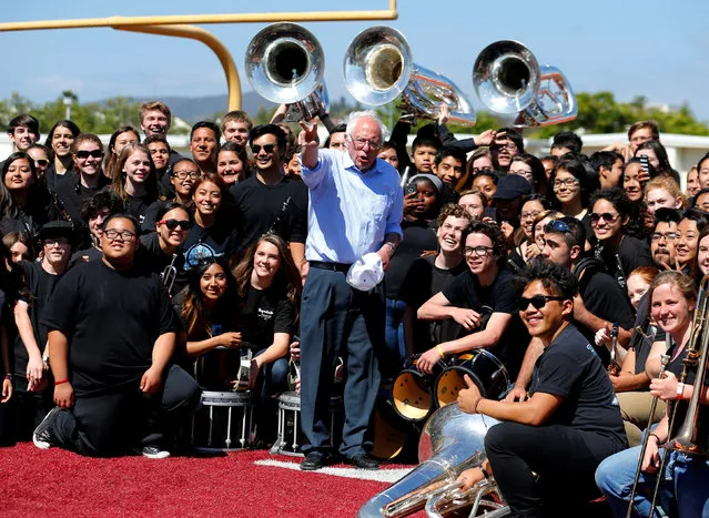 U.S. Democratic presidential candidate Bernie Sanders organizes a picture with the Rancho Buena Vista High School marching band after they played at a rally for Sanders at their High School in Vista, California, United States May 22, 2016. (Photo by Mike Blake/Reuters)