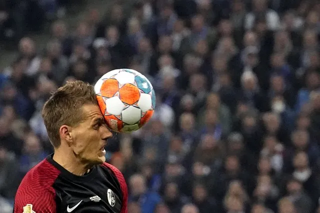 Freiburg's Nils Petersen heads the ball and scores against Hamburger during the German Cup, semifinal soccer match between Hamburger SV and SC Freiburg in Hamburg, Germany, Tuesday, April 19, 2022. (Photo by Martin Meissner/AP Photo)