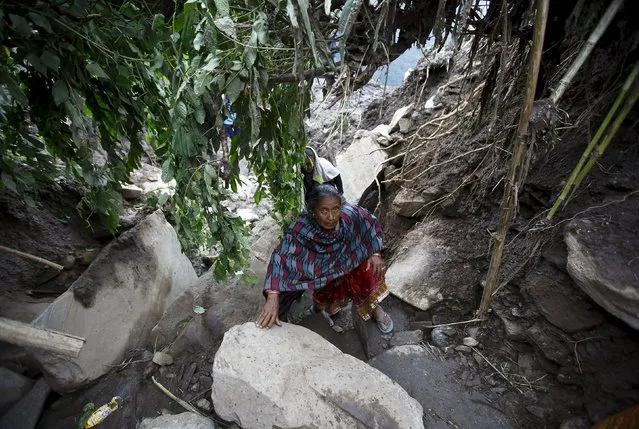 A woman walks along the landslide-affected area at Lumle village in Kaski district July 30, 2015. (Photo by Navesh Chitrakar/Reuters)