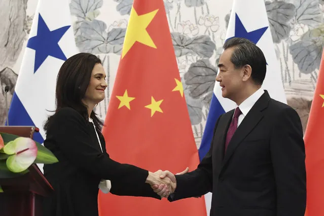Panama's Foreign Minister Isabel de Saint Malo, left, shakes hands with Chinese Foreign Minister Wang Yi during a joint press briefing in Beijing Tuesday, June 13, 2017. (Photo by Greg Baker/Pool Photo via AP Photo)