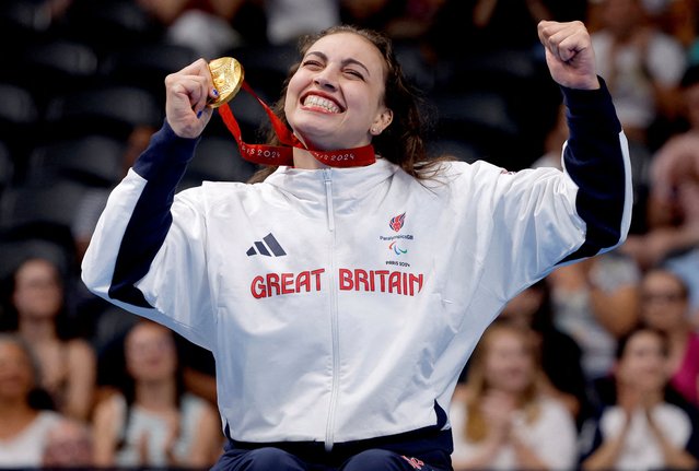 Gold medallist Grace Harvey of Britain celebrates on the podium after the women's 100m breaststroke SB5 final in Nanterre, France on September 1, 2024. (Photo by Andrew Couldridge/Reuters)