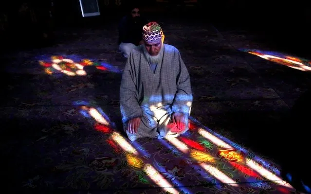 A Kashmiri Muslim offers prayers inside the shrine of Syed Abdul Qadir Jeelani, commonly known as Gousul Azam Dastageer, in Srinagar, India, Friday, December 27, 2019. Hundreds of Kashmiri Muslims who believe in Sufism throng the shrine to offer prayers everyday. (Photo by Mukhtar Khan/AP Photo)