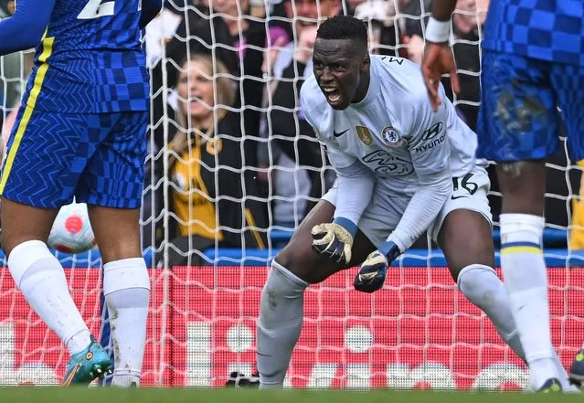 Chelsea's French-born Senegalese goalkeeper Edouard Mendy reacts after conceding a goal to Wolverhampton Wanderers' Portuguese striker Francisco Trincao (unseen) during the English Premier League football match between Chelsea and Wolverhampton Wanderers at Stamford Bridge in London on May 7, 2022. (Photo by Justin Tallis/AFP Photo)