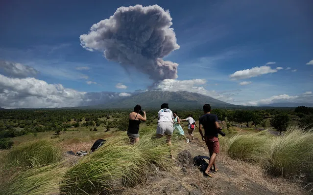 A plume of ash is released as Mount Agung volcano erupts, seen from the Kubu subdistrict in Karangasem Regency on Indonesia's resort island of Bali on May 31, 2019. (Photo by Made Alit Suantara/AFP Photo)