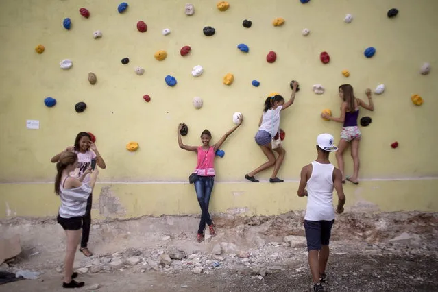 People interact with Muro de Empirismo, or Empiricism Wall, by Cuban artist Dayan Diaz, for the 12th Havana Biennial in Havana June 1, 2015. (Photo by Alexandre Meneghini/Reuters)