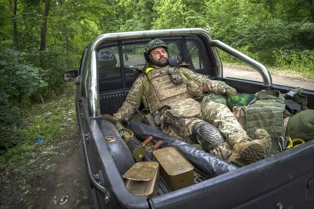 A Ukrainian serviceman pauses before going back to the frontline in the Donetsk oblast region, eastern Ukraine, Sunday, June 5, 2022. (Photo by Bernat Armangue/AP Photo)
