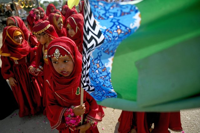 Sunni Muslim girls carry a religious flag as they take part in a rally to celebrate Eid-e-Milad-un-Nabi, the birthday of Prophet Mohammed, in Karachi on September 17, 2024. (Photo by Rizwan Tabassum/AFP Photo)