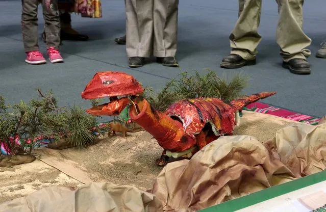 A dinosaur robot built with recycled materials is pictured during the annual robotics fair supported by Bolivian Education Ministry in La Paz, August 10, 2015. (Photo by David Mercado/Reuters)