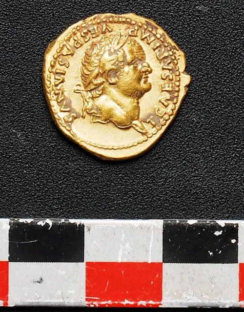 An undated picture made available by the Pompeii Archeological site Press Office, showing a gold coin recently discovered in Pompeii, near Naples, Italy. Italian and French archaeologist team, digging in the outskirts of Pompeii, have discovered four skeletons and gold coins in the ruins of an ancient shop. Pompeii archaeological site officials said Friday, June 24, 2016, the skeletons are those of young people, including an adolescent girl, who perished in the back of the shop when Mount Vesuvius erupted in 79. (Photo by Pompeii Archeological Site Press Office via AP Photo)