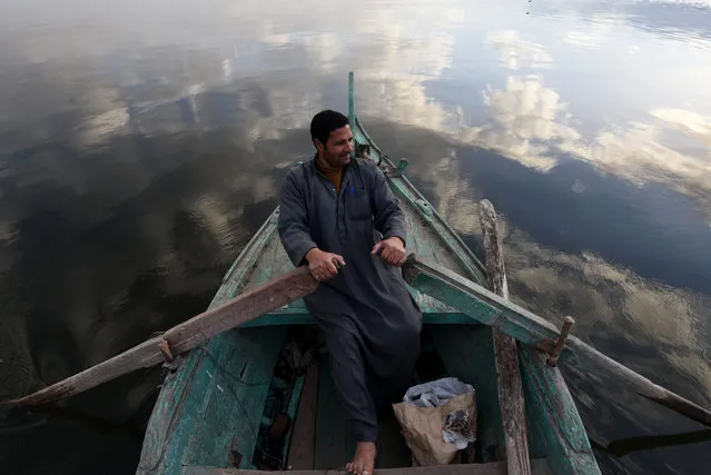 An Egyptian fisherman sits in his boat in the Egyptian Nile Delta province of al-Minufiyah, near the town of Ashmun, on March 10, 2017. (Photo by Mohamed El-Shahed/AFP Photo)