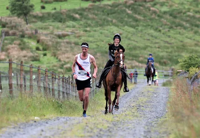 Competitors take part in the Whole Earth Man v Horse race in Llanwrtyd Wells, Wales on June 11, 2022. Running for over 40 years, Man v Horse is an epic 22.5-mile challenge which pits humans against horses across a multi-terrain course. It is being staged for the first time after a two year absence due to the Covid Pandemic. (Photo by Gareth Everett/Huw Evans Agency)