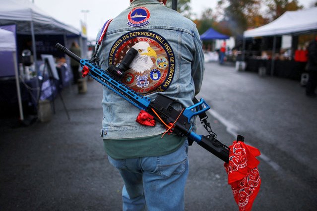 An attendee carries a rifle at the Rod of Iron Freedom Festival, in Greeley, Pennsylvania, on October 13, 2024. (Photo by Brian Snyder/Reuters)