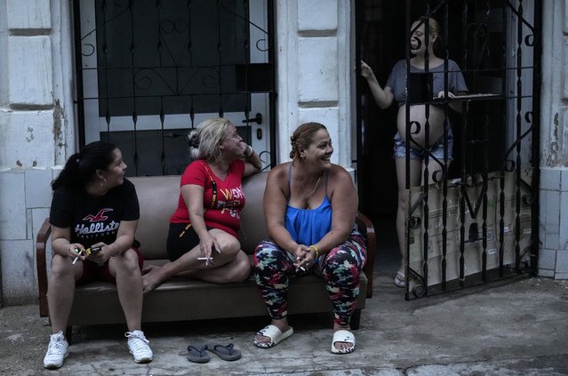 Residents pass the time during a massive blackout after a major power plant failed in Havana, Cuba, Friday, October 18, 2024. (Photo by Ramon Espinosa/AP Photo)