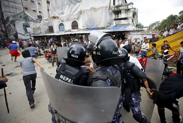 Police detain a protester (C) during a rally organised by a 30-party alliance led by a hardline faction of former Maoist rebels, who are protesting against the draft of the new constitution, in Kathmandu August 15, 2015. (Photo by Navesh Chitrakar/Reuters)