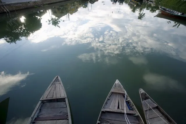 Houses are seen reflected on Hoai river in Vietnam's central ancient town of Hoi An, a UNESCO heritage site, June 26, 2015. Photo taken on June 26, 2015. (Photo by Reuters/Kham)
