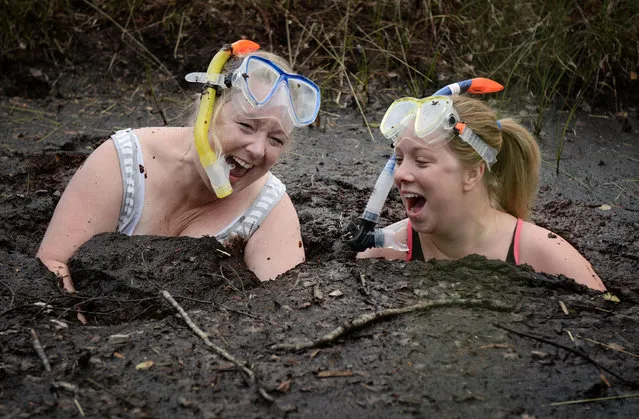 Two female entrants take a dip in the Bog Jacuzzi after takes part in the Irish Bog Snorkelling championship this afternoon at Peatlands Park on July 27, 2014 in Dungannon, Northern Ireland. The annual event sees male and female competitors swim the 60m length of the bog watched by scores of spectators and takes place on International Bog Day. (Photo by Charles McQuillan/Getty Images)