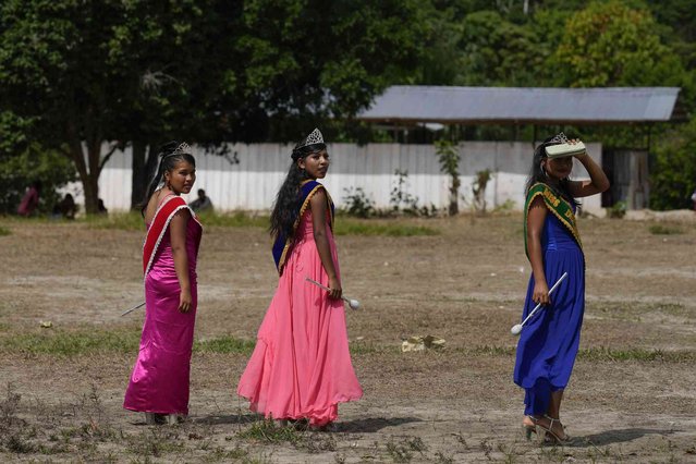 Students crowned Queen of the Anniversary of the Ricardo Palma school walk through a field in Kigkis, Peru, Wednesday, June 26, 2024. (Photo by Martin Mejia/AP Photo)