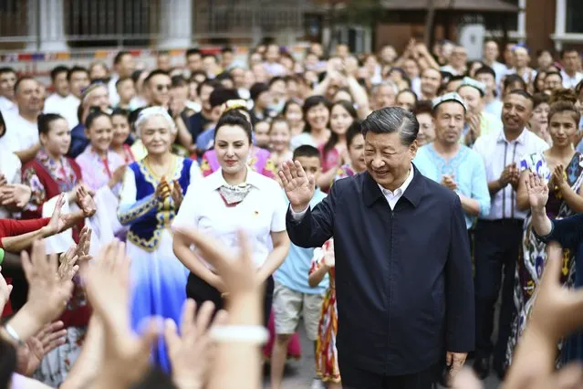 In this photo released by China's Xinhua News Agency, Chinese President Xi Jinping, center, visits the community of Guyuanxiang in the Tianshan District in Urumqi in northwestern China's Xinjiang Uyghur Autonomous Region, Wednesday, July 13, 2022. (Photo by Yan Yan/Xinhua via AP Photo)
