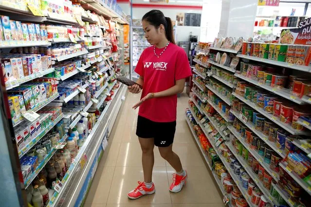 Thailand's badminton player Ratchanok Intanon (C), who hopes to win gold at the Rio Olympics, shops after an afternoon training session at a convenience store in Bangkok, Thailand, June 22, 2016. (Photo by Athit Perawongmetha/Reuters)