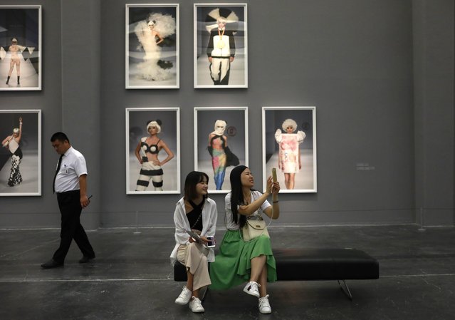 Visitors look at artworks by Chinese artist Zhao Bandi during the “Zhao Bandi: China Party” exhibition at Ullens Center for Contemporary Art (UCCA) in the 798 Art district in Beijing, China, 26 August 2017. The exhibition showcase nearly three decades of the artist's career showing more than a dozen of his works and projects from 1987 to the present including fashion design, video, film, performance, and painting. (Photo by How Hwee Young/EPA/EFE)