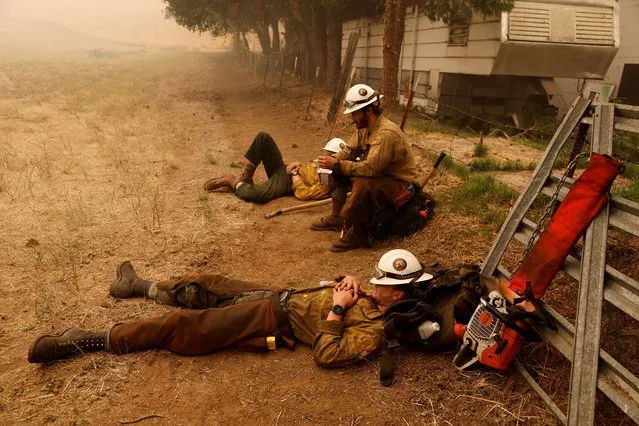 Klamath Interagency Hotshots rest while waiting for a new assignment as the McKinney Fire burns near Yreka, California, U.S., July 31, 2022. (Photo by Fred Greaves/Reuters)