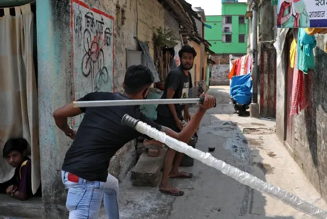 A plainclothes policeman wields his baton against a man as a punishment for breaking the lockdown rules, after India ordered a 21-day nationwide lockdown to limit the spreading of coronavirus disease (COVID-19), in Kolkata, India, March 25, 2020. (Photo by Rupak De Chowdhuri/Reuters)