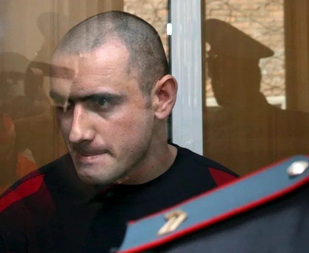 The only Beslan hostage taker caught alive Nurpashi Kulayev stands in a jail listening the verdict announcement during the last day of the trial in the court of Vladikavkaz, Friday 26 May 2006. Nurpashi Kulayev was sentenced to death, changed by the court for life imprisonment because there is a death penalty moratorium in Russia. (Photo by Zurab Kurtsikidze/EPA)