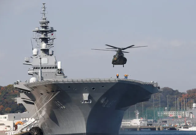 A helicopter lands on the Izumo, Japan Maritime Self Defense Force's (JMSDF) helicopter carrier, at JMSDF Yokosuka base in Yokosuka, south of Tokyo, Japan, December 6, 2016. (Photo by Kim Kyung-Hoon/Reuters)