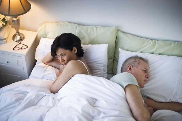 Mature couple laying in bed after argument in New Jersey. (Photo by Tetra Images/Getty Images)