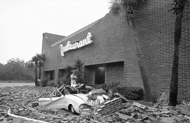 An auto lies crushed beneath bricks blown down by hurricane Dora winds at a restaurant on Jekyll Island, Ga., on September 10, 1964. (Photo by AP Photo)