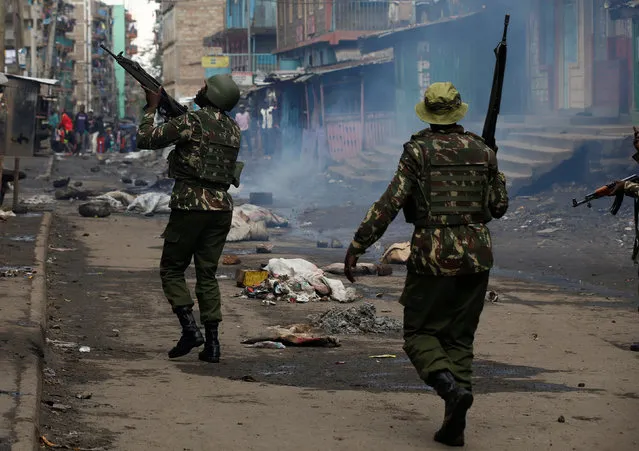 Police officers disperse opposition supporters during a protest in the slum area of Mathare in the capital Nairobi, Kenya on October 26, 2017. (Photo by Siegfried Modola/Reuters)