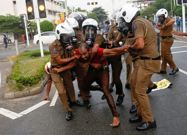Sri Lankan police officers detain a demonstrator during an anti-government protest by Inter-University Student's Federation, amid the country's economic crisis, in Colombo, Sri Lanka on August 30, 2022. (Photo by Dinuka Liyanawatte/Reuters)